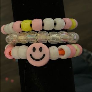 Bracelet set of three, pink and yellow themed.